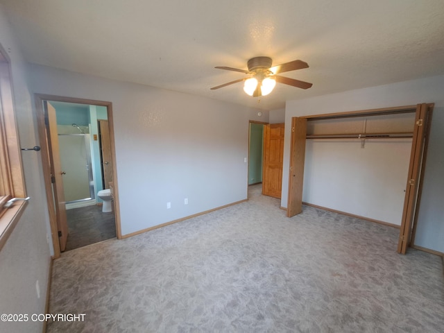 unfurnished bedroom with light carpet, baseboards, connected bathroom, ceiling fan, and a closet