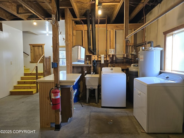 utility room with washing machine and dryer and water heater