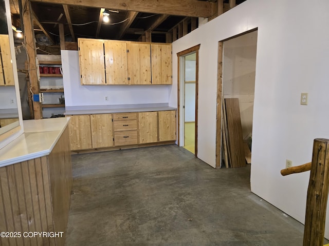 kitchen featuring concrete floors, light brown cabinets, and light countertops