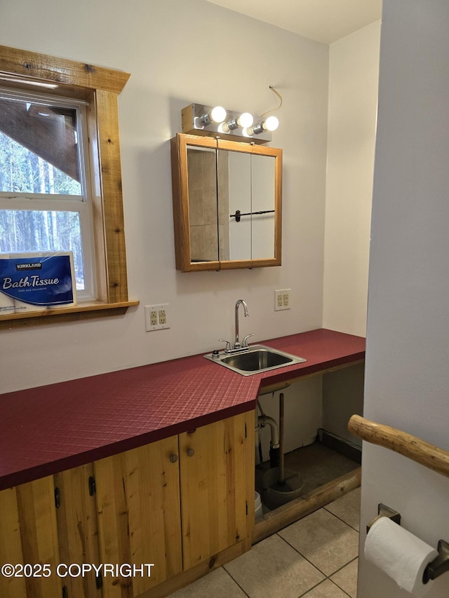 bathroom with a sink and tile patterned floors