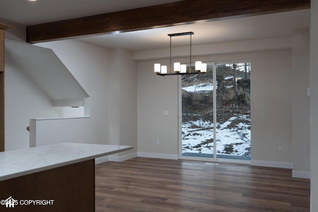 unfurnished dining area featuring an inviting chandelier, baseboards, dark wood-style floors, and beam ceiling