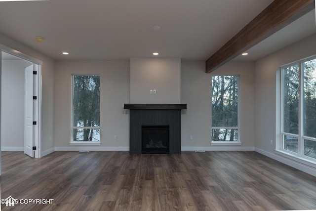 unfurnished living room featuring a fireplace, beamed ceiling, dark wood-type flooring, and recessed lighting