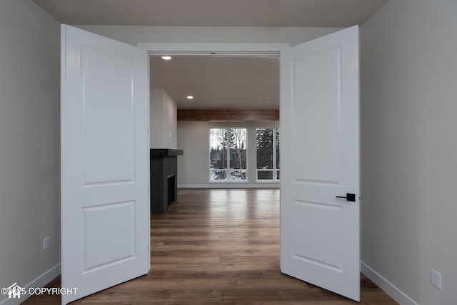 hall featuring dark wood-style floors, recessed lighting, and baseboards