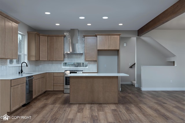 kitchen featuring dishwashing machine, a kitchen island, stainless steel gas range, wall chimney range hood, and a sink