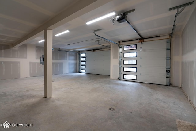 garage featuring electric panel and a garage door opener