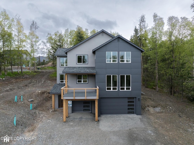 14311 Pickett St, Anchorage, AK 99516 - back of property with a garage, a shingled roof, and gravel driveway