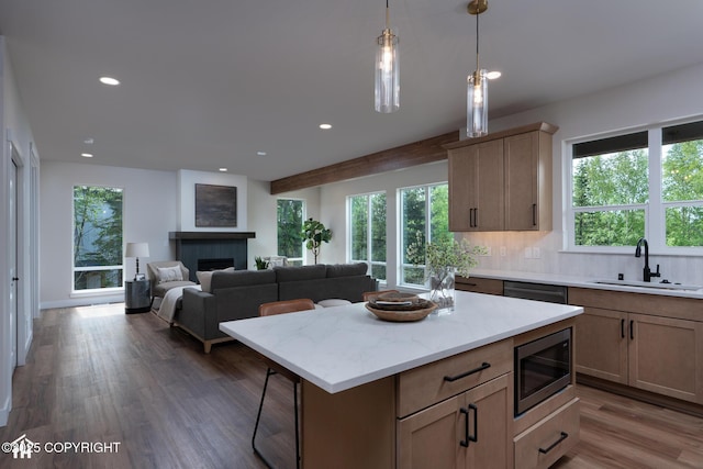 14311 Pickett St, Anchorage, AK 99516 - kitchen with appliances with stainless steel finishes, wood finished floors, a fireplace, recessed lighting, and decorative backsplash
