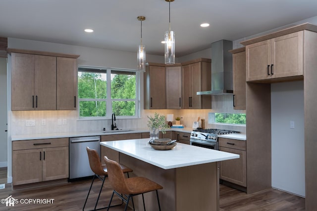 14311 Pickett St, Anchorage, AK 99516 - kitchen featuring stainless steel appliances, wall chimney exhaust hood, dark wood-style flooring, backsplash, and light countertops