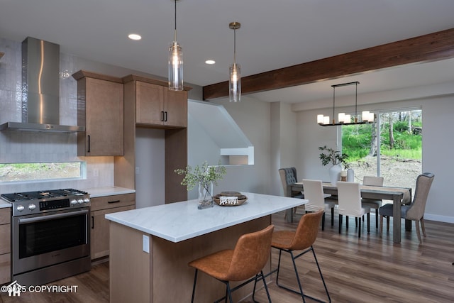 14311 Pickett St, Anchorage, AK 99516 - kitchen with wall chimney exhaust hood, stainless steel gas stove, dark wood-style flooring, beam ceiling, and a kitchen island