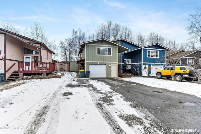 view of front of home featuring a garage, driveway, and stairs