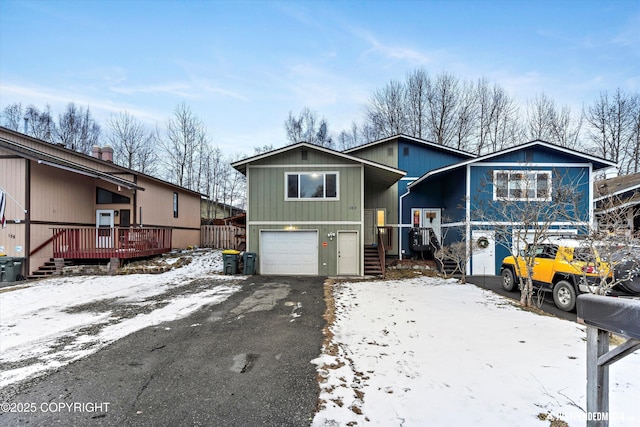 view of front of property featuring an attached garage and aphalt driveway