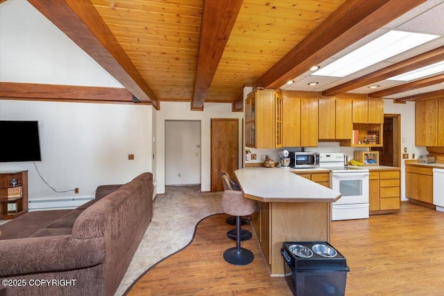 kitchen featuring open floor plan, light countertops, and white appliances