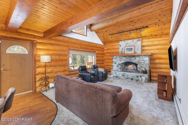 living area with rustic walls, wooden ceiling, beamed ceiling, rail lighting, and a fireplace