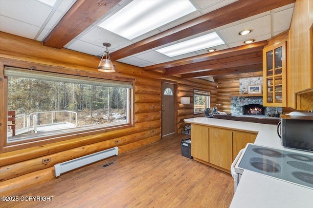 kitchen with a baseboard radiator, beamed ceiling, a fireplace, pendant lighting, and white range with electric cooktop