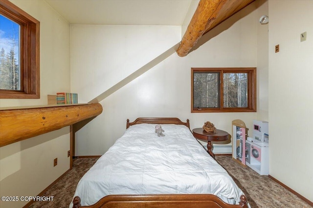 carpeted bedroom featuring beam ceiling and baseboards