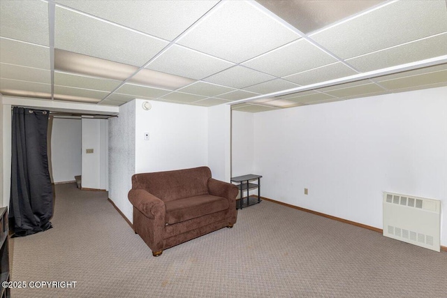 sitting room with a paneled ceiling, baseboards, carpet floors, and radiator heating unit