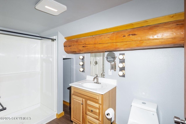 full bath featuring a stall shower, vanity, and toilet