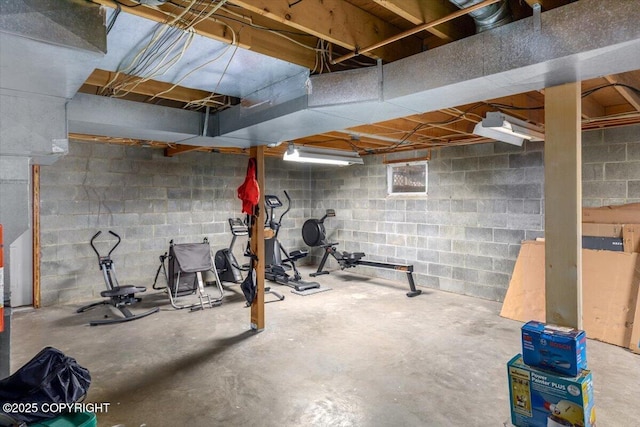 exercise area featuring concrete block wall