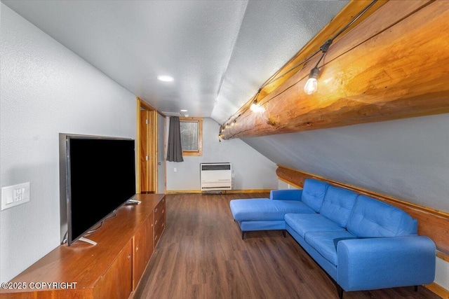 unfurnished living room with baseboards, lofted ceiling, wood finished floors, heating unit, and a textured ceiling