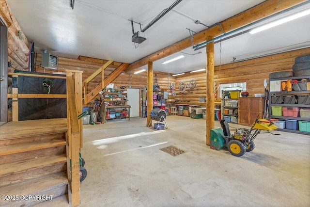 garage with a garage door opener and a workshop area