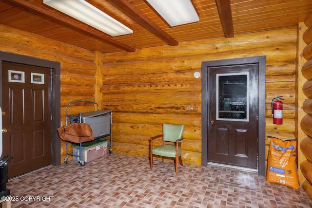 entryway with wood ceiling, brick floor, and beam ceiling