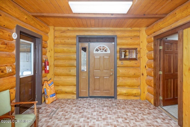 entrance foyer featuring rustic walls, brick floor, and wood ceiling