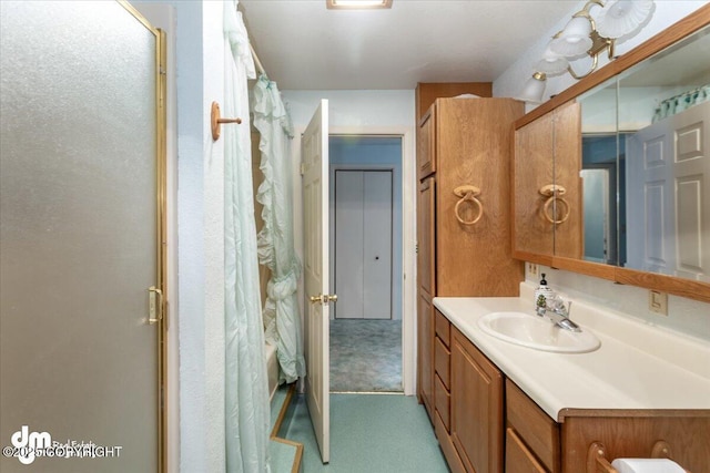 bathroom featuring curtained shower and vanity