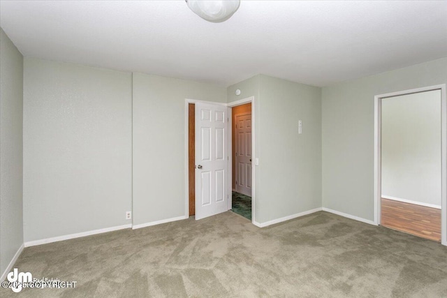 unfurnished bedroom with baseboards and carpet flooring