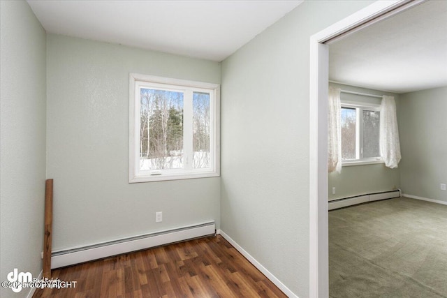 unfurnished room featuring baseboards, baseboard heating, and a healthy amount of sunlight