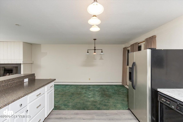 kitchen featuring a baseboard heating unit, a fireplace, black dishwasher, stainless steel fridge, and pendant lighting