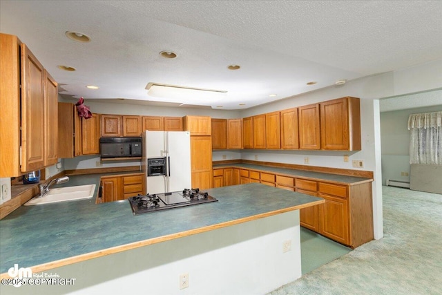 kitchen with a textured ceiling, light colored carpet, a sink, baseboard heating, and black appliances