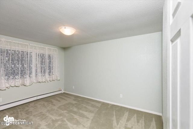 carpeted empty room featuring a textured ceiling, baseboard heating, and baseboards