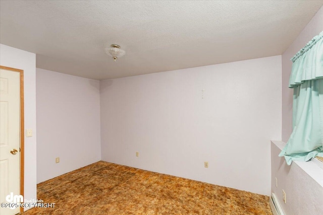 spare room with a textured ceiling and carpet flooring