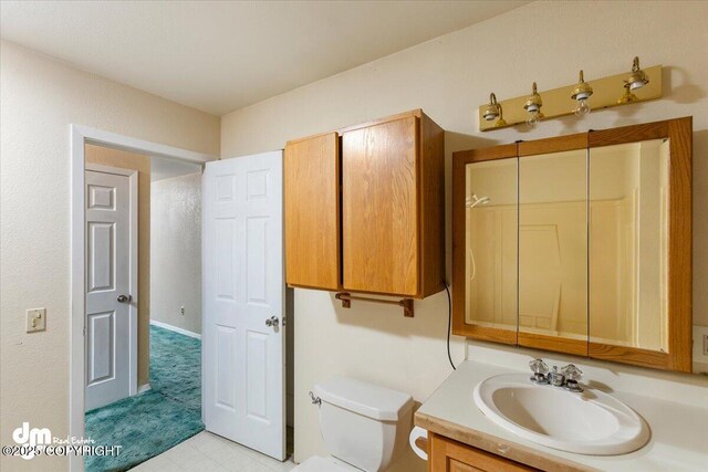 bathroom featuring toilet and vanity