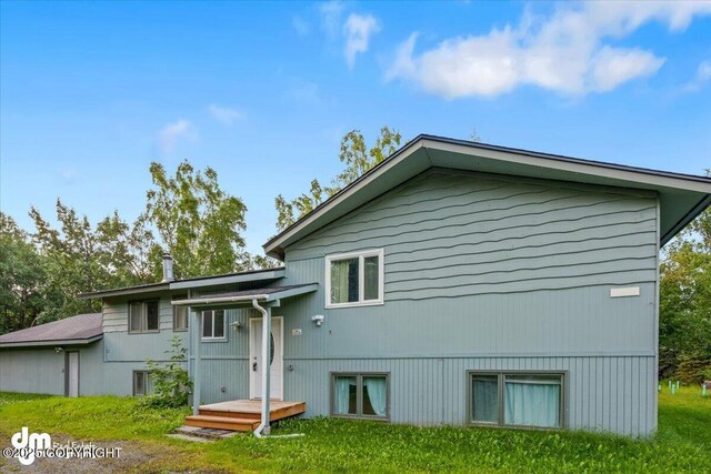 rear view of house with a lawn