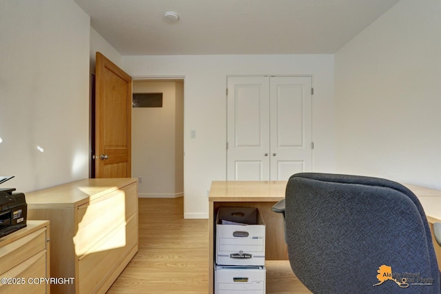 office featuring baseboards and light wood-style floors
