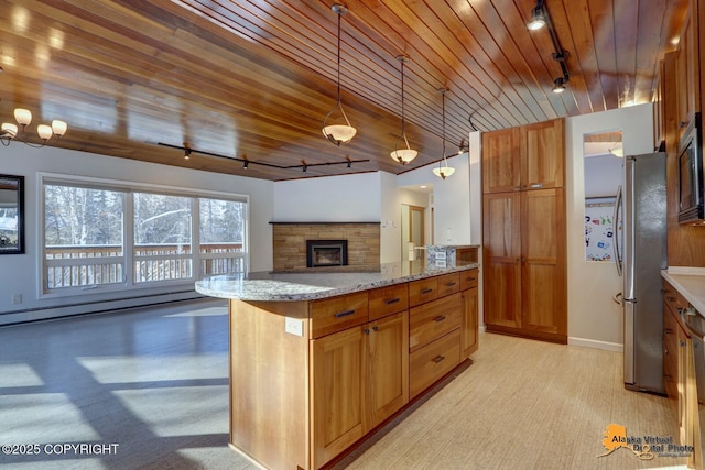 kitchen with a baseboard radiator, light stone counters, wood ceiling, rail lighting, and freestanding refrigerator