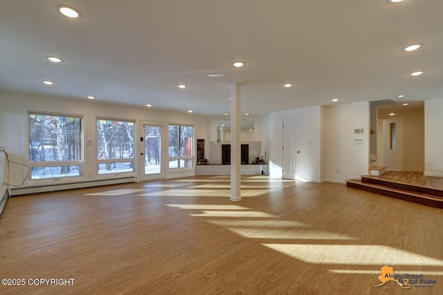 interior space featuring stairway, a baseboard radiator, light wood-style flooring, baseboards, and recessed lighting