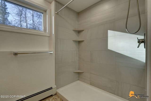 bathroom featuring a baseboard heating unit and a tile shower