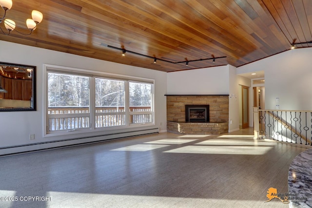 unfurnished living room featuring rail lighting, a fireplace, baseboards, wood ceiling, and a baseboard radiator