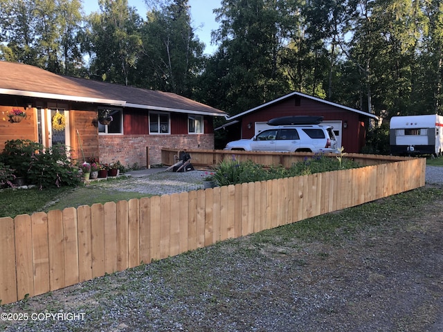 view of front of house featuring brick siding and a detached garage