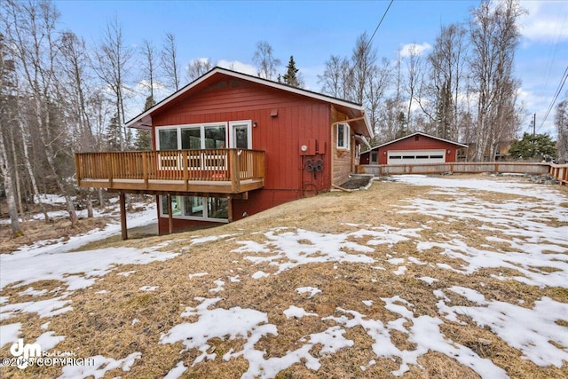 view of front facade featuring a wooden deck and a garage