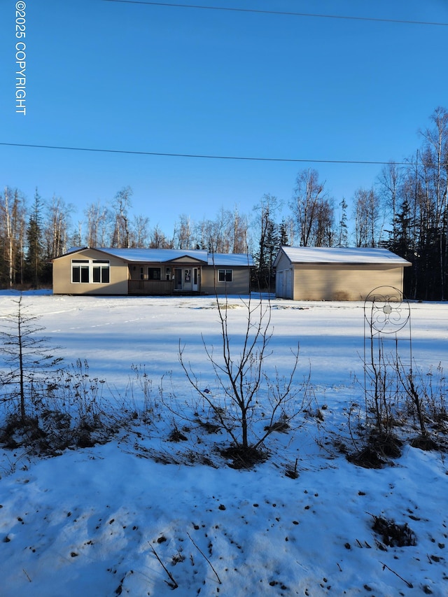 exterior space featuring a garage, a shed, and an outbuilding