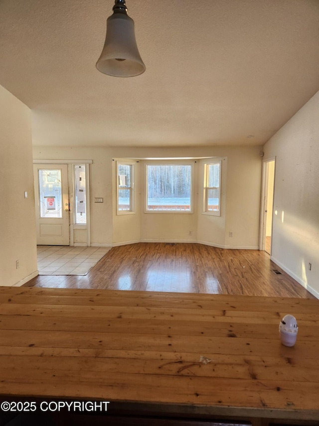 entryway with baseboards and hardwood / wood-style floors