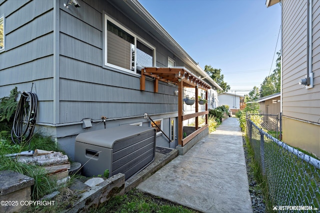 view of property exterior featuring fence