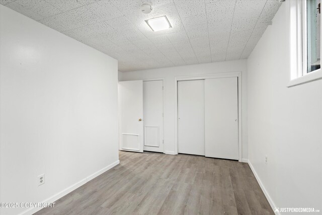521 N St, Anchorage, AK 99501 - unfurnished bedroom with baseboards and wood finished floors