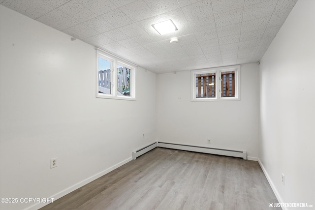 521 N St, Anchorage, AK 99501 - basement with baseboards, baseboard heating, and wood finished floors
