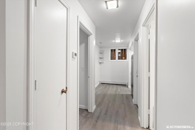 521 N St, Anchorage, AK 99501 - hallway with a baseboard radiator, baseboards, and light wood-type flooring