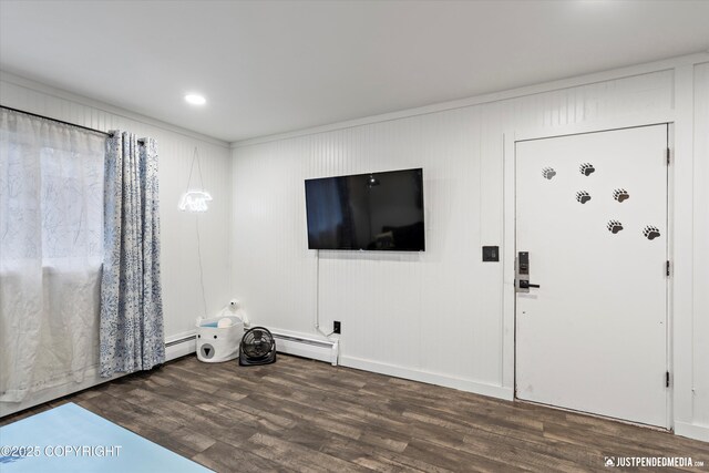 521 N St, Anchorage, AK 99501 - unfurnished living room featuring wood finished floors and a baseboard heating unit