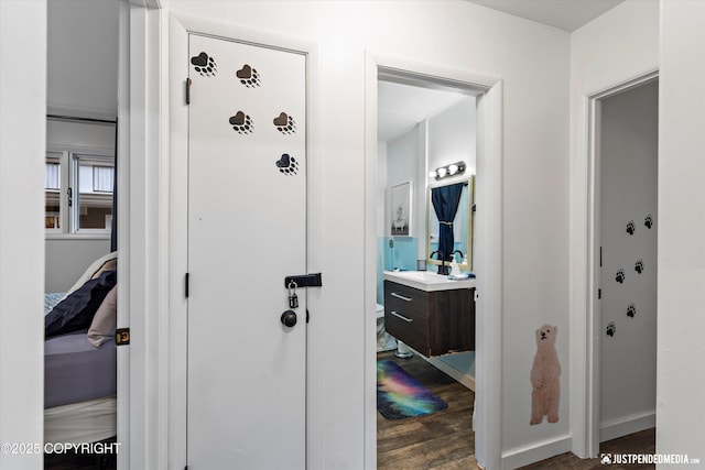 521 N St, Anchorage, AK 99501 - hall with dark wood-type flooring, baseboards, and a sink